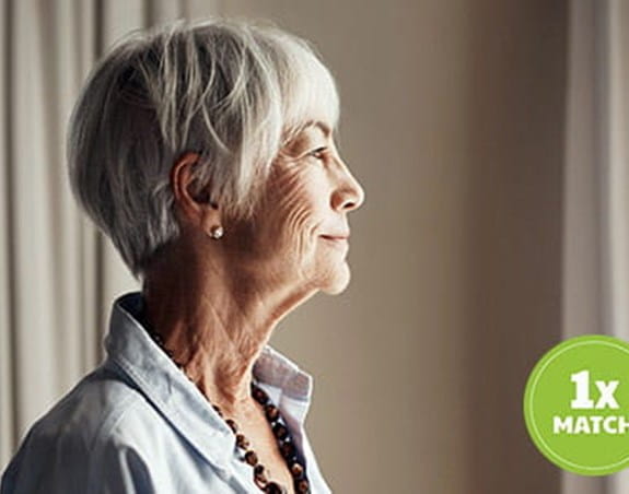 An older woman looks into the distance.