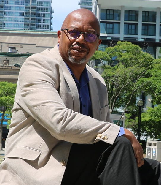 A photo of Kevin Trotman sitting outside on a sunny day