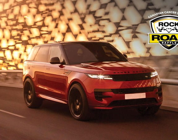A Range Rover SUV driving across a bridge and the Canadian Cancer Society Rock the Road Raffle logo in the corner.