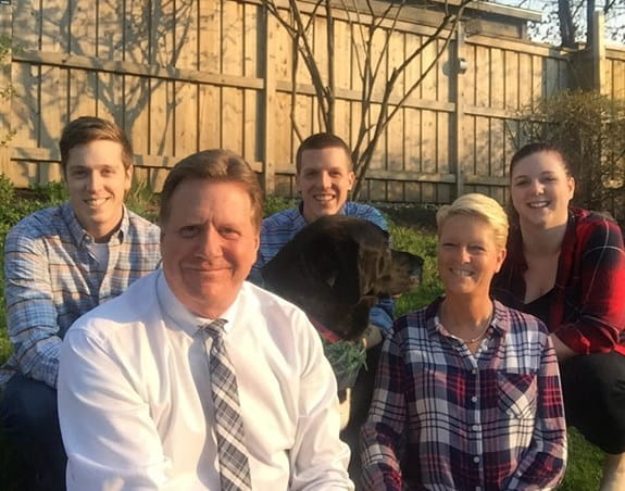 Brian is pictured with his wife and children.