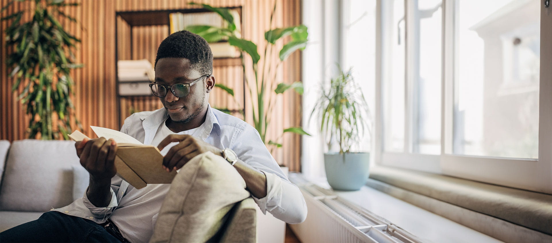 Man reading on a sofa. 