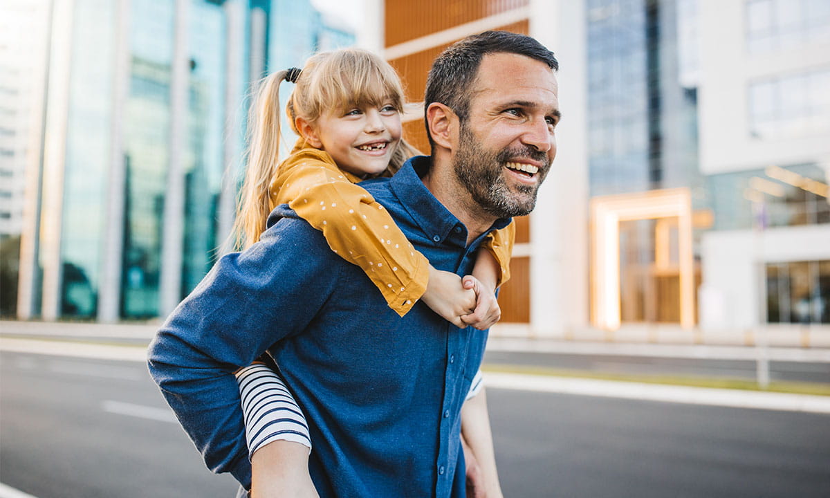 Father and daughter walking downtown. 