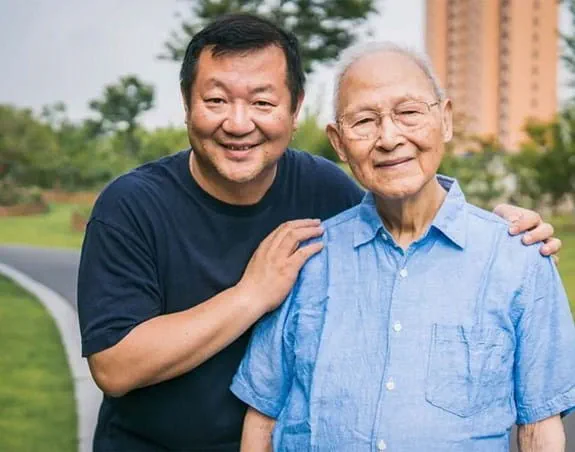 Two men smiling